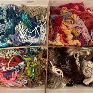 colourful boxes of rug hooking materials