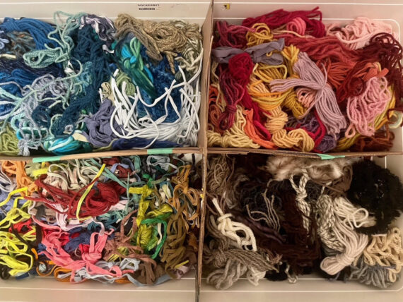 colourful boxes of rug hooking materials