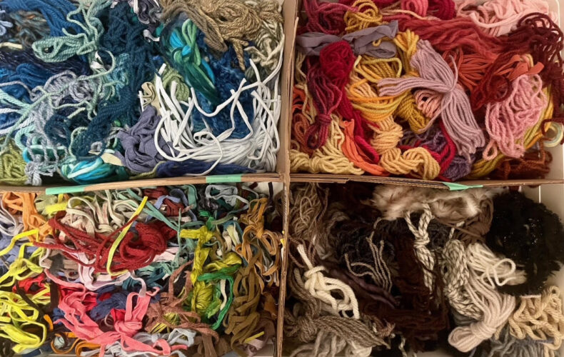 colourful boxes of rug hooking materials